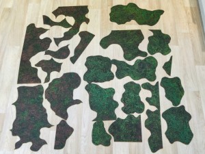 Cut-up parts of the forest battle mat laid out together on the floor